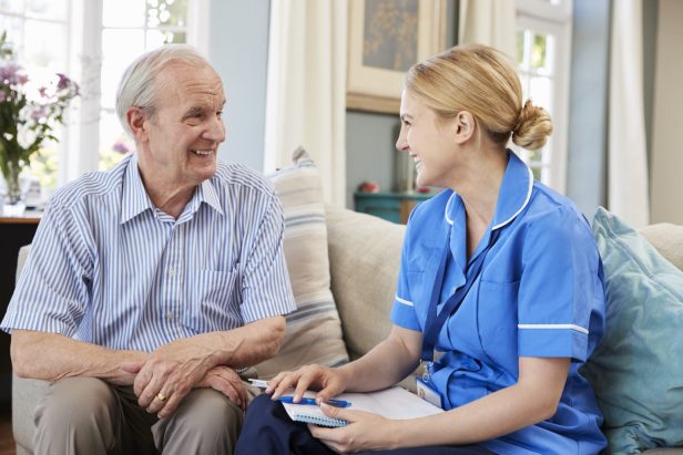 Female Community Nurse Visits Senior Man At Home