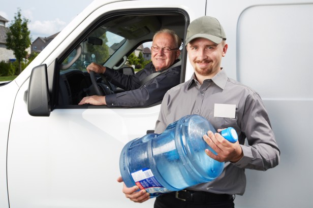 Water delivery service man with big bottle.